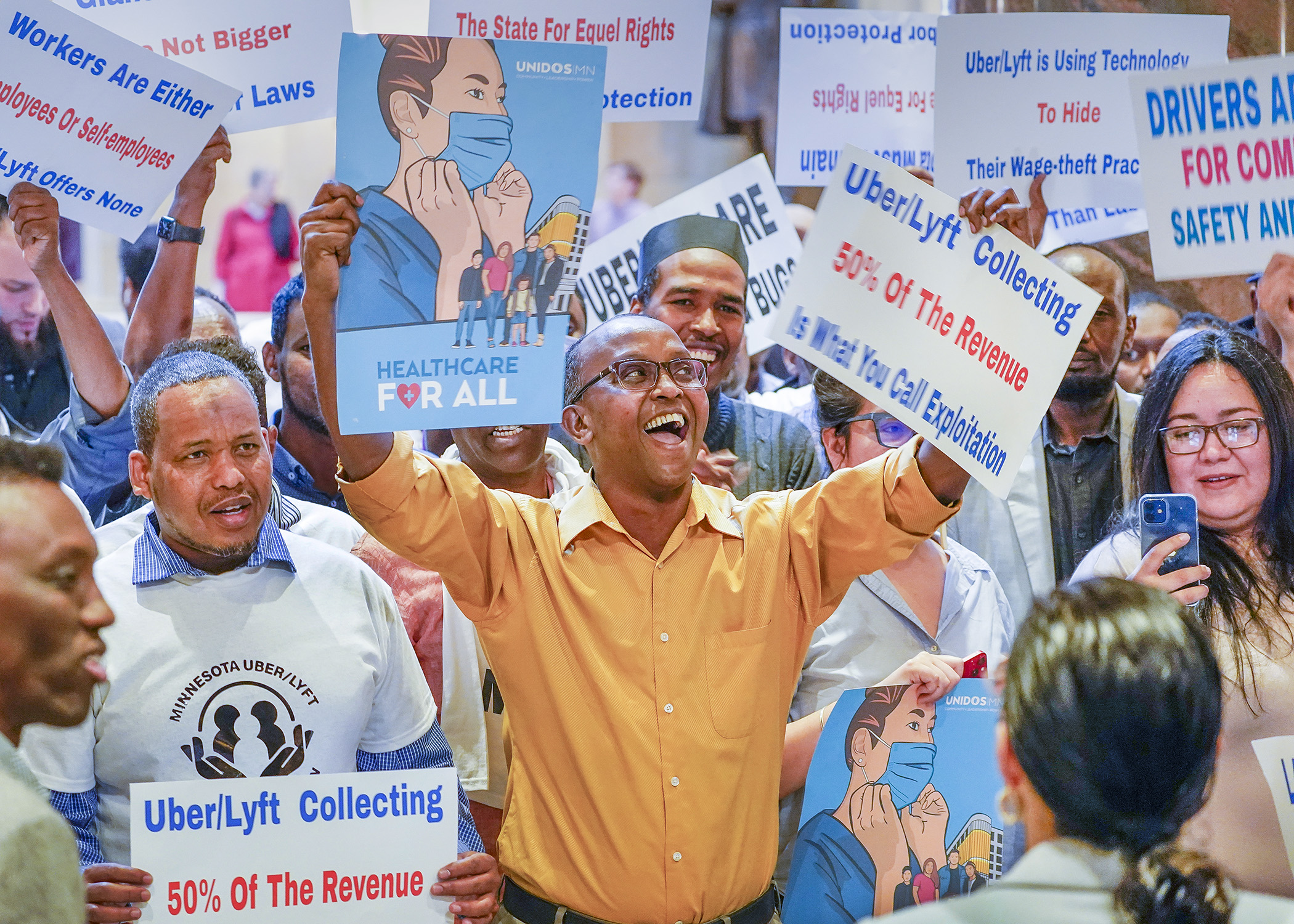 Supporters of a bill that would establish protections for transportation network company drivers rally in front of the House Chamber May 17. (Photo by Andrew VonBank)